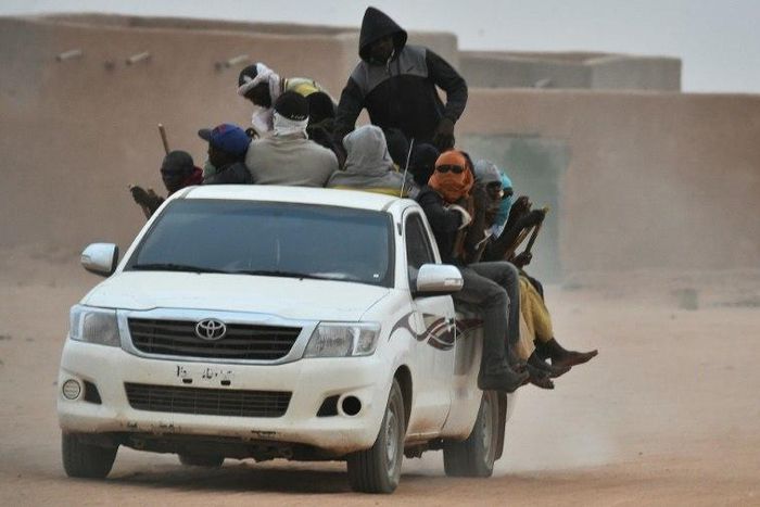 A vehicle carrying migrants travels through Agadez, Niger, en route to Libya in June 2015