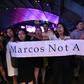 Protesters demonstrate in Manila following the burial of the late dictator Ferdinand Marcos in a secretive ceremony at the national heroes' cemetery
