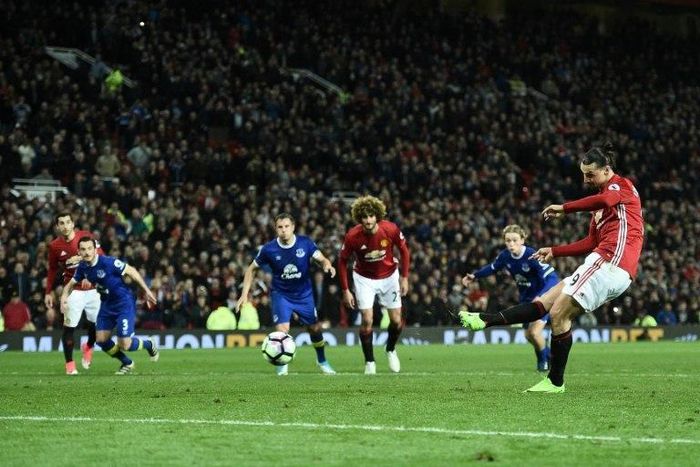 Manchester United's striker Zlatan Ibrahimovic shoots from the penalty spot to scores his team's first goal during the English Premier League football match against Everton at Old Trafford in Manchester, England, on April 4, 2017