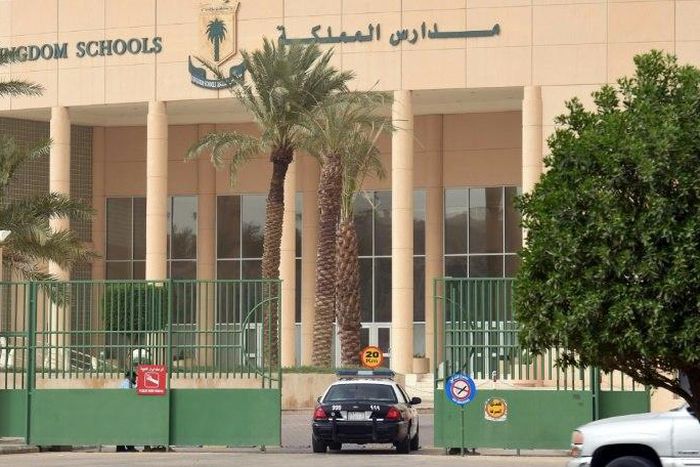 A police car passes through the main entrance of the Kingdom School in Riyadh on May 31, 2017