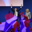 Emmanuel Macron and his wife Brigitte Trogneux salute the crowd after projections indicated the 39-year-old centrist led first round voting in France's presidential elections