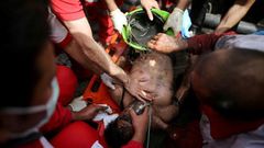 Rescue workers try to resuscitate a coal miner after he was pulled out from a mine in Azadshahr, northern Iran, following an explosion which left dozens of miners trapped on May 3, 2017
