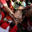Rescue workers try to resuscitate a coal miner after he was pulled out from a mine in Azadshahr, northern Iran, following an explosion which left dozens of miners trapped on May 3, 2017