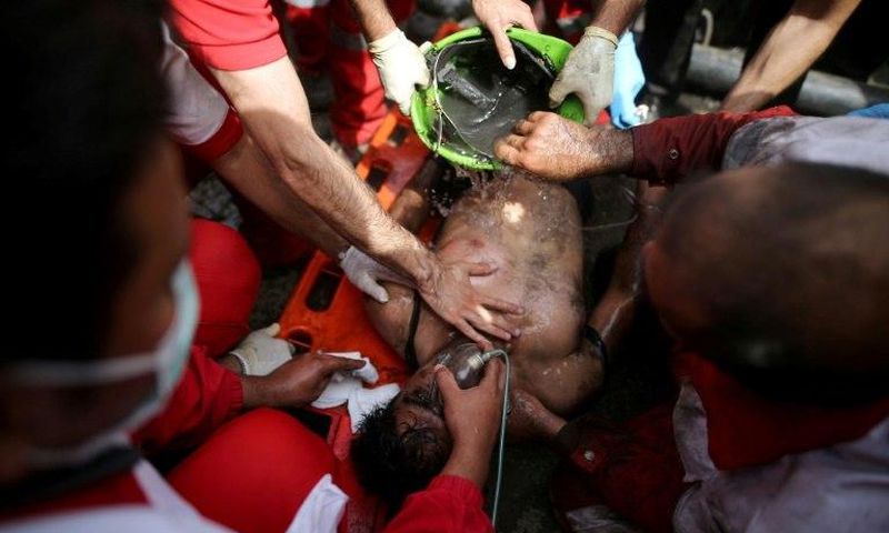 Rescue workers try to resuscitate a coal miner after he was pulled out from a mine in Azadshahr, northern Iran, following an explosion which left dozens of miners trapped on May 3, 2017