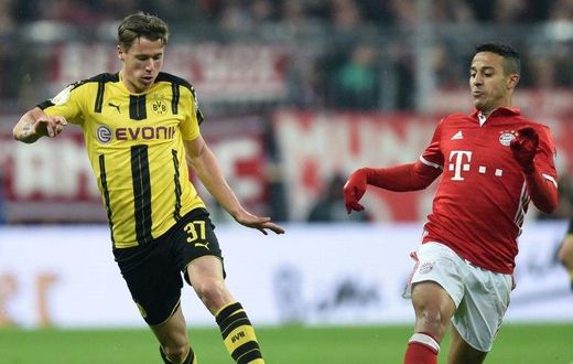 Dortmund's Erik Durm (left) and Bayern Munich's Thiago Alcantara in action during the German Cup semi-final match in Munich, on April 26, 2017