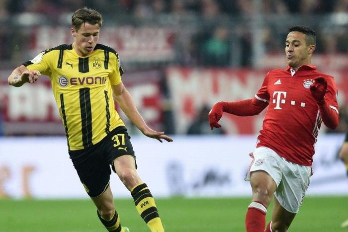 Dortmund's Erik Durm (left) and Bayern Munich's Thiago Alcantara in action during the German Cup semi-final match in Munich, on April 26, 2017