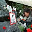 A relative of the Caravan of Death incident places flowers in the Memorial to the Detained and Disappeared at the Santiago cemetery, on July 21, 1999