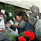 A relative of the Caravan of Death incident places flowers in the Memorial to the Detained and Disappeared at the Santiago cemetery, on July 21, 1999