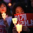 Protesters hold candles and banners calling for the resignation of South Korea's President Park Geun-Hye during a rally in Seoul on November 19, 2016