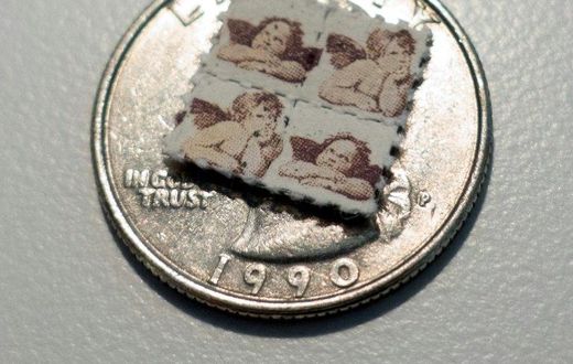 LSD blotter tabs on a US quarter coin, used as part of an illegal and potentially risky trend, of taking tiny amounts of psychedelic drugs too boost work or treat ailments