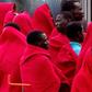 A group of migrants cover themselves with blankets following their arrival on board of a Spanish coast guard vessel into the southern Spanish port of Malaga on December 3, 2016