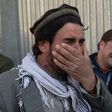 Afghan men weep for their relatives outside the main military hospital in Kabul, on March 8, 2017