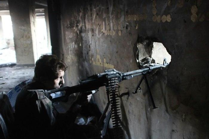 A member of Syria's pro-government forces guards a look out point as they advance Aleppo's rebel-held Bustan al-Basha neighbourhood on October 6, 2016