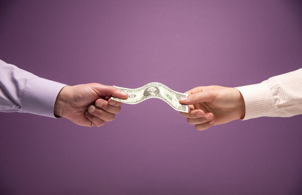 Two hands holding a US 1 dollar bill