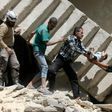 Syrian rescuers remove a baby from under rubble in al-Kalasa in northern Aleppo in April last year