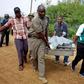 Policemen carry the dead bodies