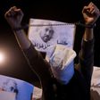 Demonstrators in Morocco's neglected northern Rif region hold pictures of arrested protest leader Nasser Zafzafi during a night-time rally in the city of Al-Hoceima on May 30, 2017