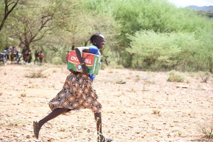 Resident of Tiaty Subcounty with the carton of beer donated (Nation)