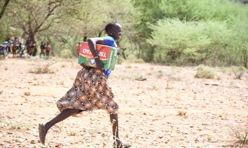 Resident of Tiaty Subcounty with the carton of beer donated (Nation)