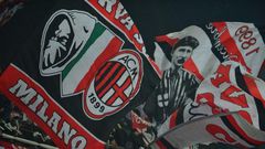 AC Milan supporters wave flags during a serie A match against Juventus