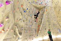 young sporty couple of climbers in a climbing hall
