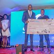 Samuel Abisai receiving  his cheque