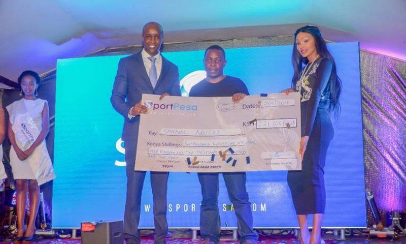 Samuel Abisai receiving  his cheque