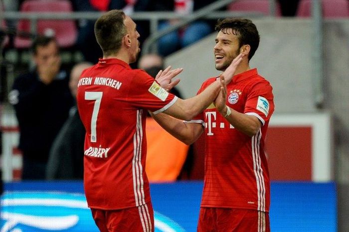 Bayern Munich's midfielder Franck Ribery (L) celebrates his 0-3 goal with defender Juan Bernat during the German First division Bundesliga football match against Cologne March 4, 2017