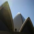 Tourists walk outside the Sydney Opera House on May 10, 2017