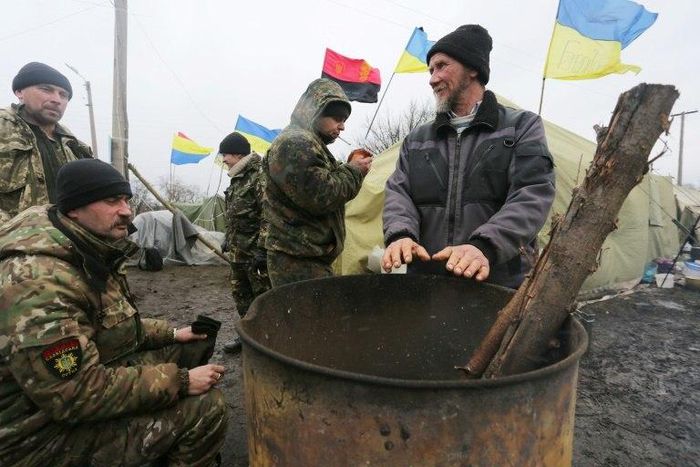 Ukrainian nationalist protesters and military veterans take part in a blockade against ongoing trade with Russian-backed insurgents at Kryvyi Torets railway station, in the Donetsk region, on February 23, 2017 The blockade consists of four different ca...