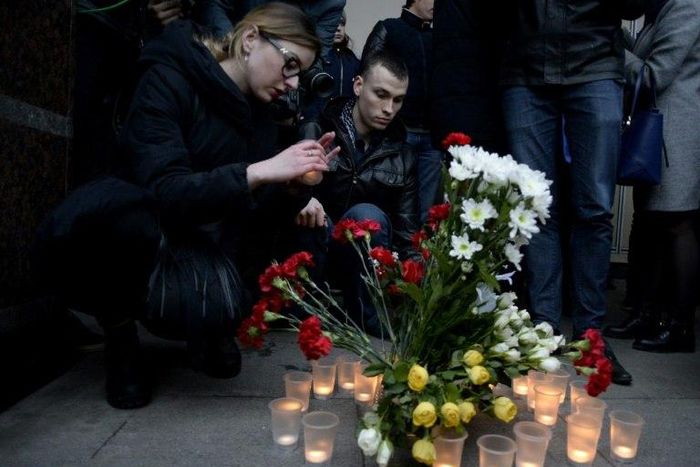 People place flowers and lit candles in memory of victims of the blast in the Saint Petersburg metro outside Sennaya Square station on April 3, 2017