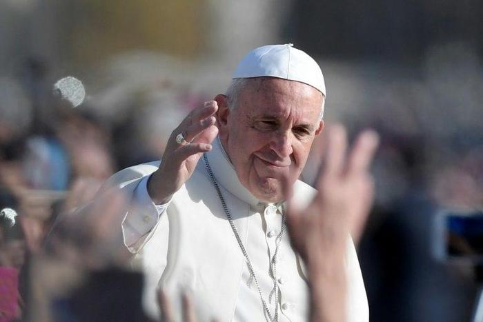 Pope Francis greets the crowd from the popemobile after a mass marking the end of the Vatican's jubilee year on November 20, 2016