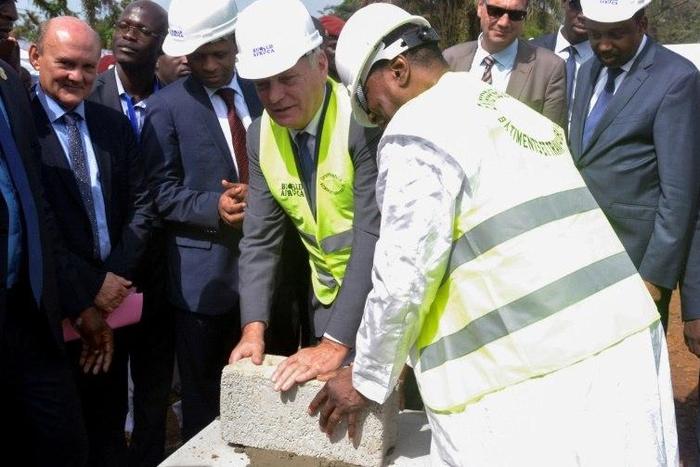 Guinean President Alpha Conde (R) and French Foreign Minister Jean-Marc Ayrauit (C) put the first stone of the upcoming Pasteur Institute in Conakry on November 11, 2016