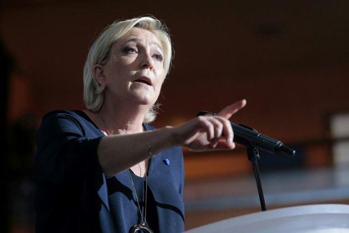 French presidential election candidate for the far-right Front National (FN) party Marine Le Pen gestures as she delivers a speech during a campaign meeting at the Palais des Congres in Ajaccio on the island of Corsica on April 8, 2017