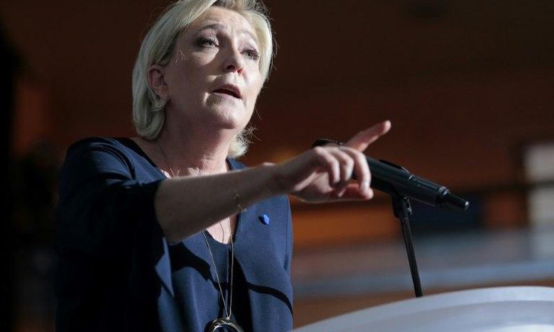 French presidential election candidate for the far-right Front National (FN) party Marine Le Pen gestures as she delivers a speech during a campaign meeting at the Palais des Congres in Ajaccio on the island of Corsica on April 8, 2017