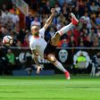 Valencia's forward Simone Zaza jumps to kick the ball during the Spanish league football match Valencia CF vs Sevilla FC at the Mestalla stadium in Valencia on April 16, 2017