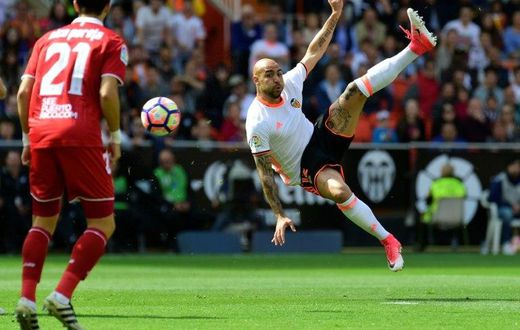 Valencia's forward Simone Zaza jumps to kick the ball during the Spanish league football match Valencia CF vs Sevilla FC at the Mestalla stadium in Valencia on April 16, 2017