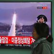 A TV screen shows file footage of a North Korean missile launch, with China's top nuclear envoy now in Seoul for talks on the North Korean threat