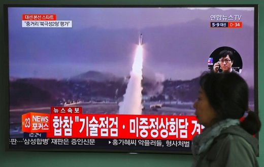 A TV screen shows file footage of a North Korean missile launch, with China's top nuclear envoy now in Seoul for talks on the North Korean threat