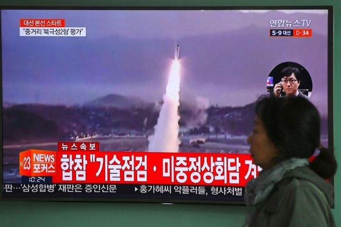 A TV screen shows file footage of a North Korean missile launch, with China's top nuclear envoy now in Seoul for talks on the North Korean threat
