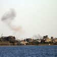 Smoke billows from buildings in the residential district of Gandoufa, in southwestern Benghazi, during clashes between Islamic State group's jihadists and the Libyan National Army
