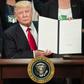US President Donald Trump signs an executive order to start the Mexico border wall project at the Department of Homeland Security facility in Washington DC, on January 25, 2017