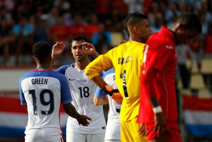 Chris Wondolowski (No. 18) of the US celebrates with teammate Julian Green after he assisted Green's goal against Cuba, at Estadio Pedro Marrero in Havana, on October 7, 2016