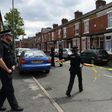 Police set a cordon outside a house in Manchester's Moss Side area on Saturday. Some local residents were evacuated and others were told to stay indoors