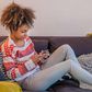 woman texting on couch