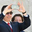 US Secretary of Treasury Steven Mnuchin snaps a picture with his smartphone at the end of a G7 summit of finance ministers where they pledged to combat cyber crime
