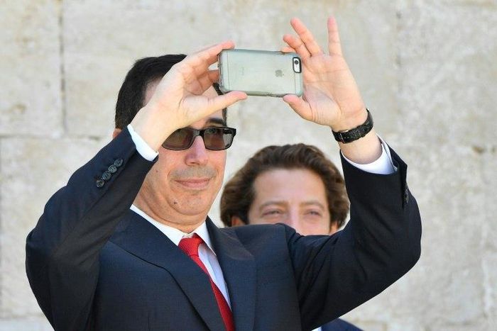 US Secretary of Treasury Steven Mnuchin snaps a picture with his smartphone at the end of a G7 summit of finance ministers where they pledged to combat cyber crime