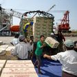 Myanmar workers load boxes of relief aid for Rohingya Muslims delivered by the humanitarian aid Malaysian ship Nautical Aliya in Yangon's Thilawa port on February 10, 2017