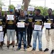 Anti-slavery activists demonstrate in Dakar against the imprisonement of fellow activists in Mauritania, holding cards with the names of those detained