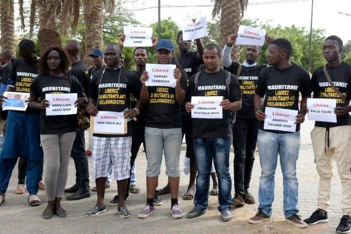Anti-slavery activists demonstrate in Dakar against the imprisonement of fellow activists in Mauritania, holding cards with the names of those detained